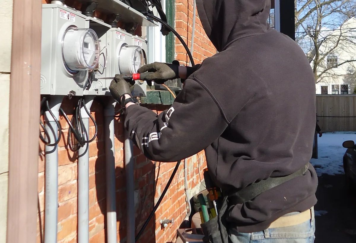 Electrician performing safe professional electrical work